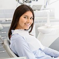Young woman leaning back in her dental chair
