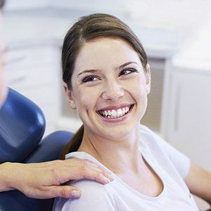 Lady in dental chair smiling