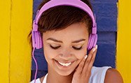 Smiling young woman wearing pink headphones