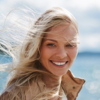 Lady with hair flowing in the wind smiling