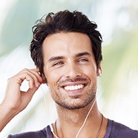 Suave man with earbuds smiling