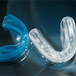closeup of two mouthguards for dental implants in Huntington Beach