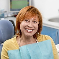 Senior lady sitting on dental chair smiling widely