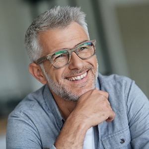 gray-haired man smiling with white teeth 