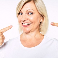 Woman pointing at smile 