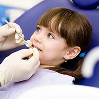 Young girl receiving fluoride treatment