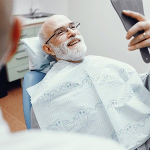 Man smiling after getting a tooth-colored filling in Huntington Beach 