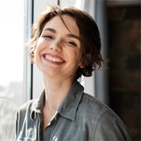 Woman smiling after getting a tooth-colored filling in Huntington Beach 