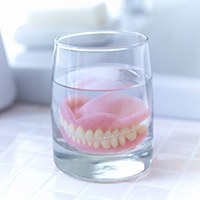 Dentures soaking in a solution