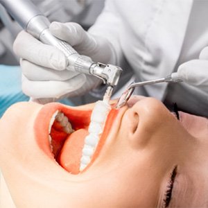 Woman receiving professional teeth cleaning