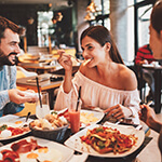 Friends enjoying meal together with help of dental implants