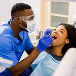 Dentist inspecting patient’s dental implants in Huntington Beach