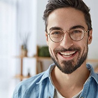 young man with dental implants in Huntington Beach smiles