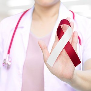 Dentist holding an oral cancer ribbon