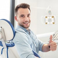 man in dental chair giving thumbs up after root canal therapy in Huntington Beach 
	Do I Need Root Canal Therapy? 
	
