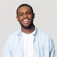 man smiling in front of a white background 
	Root Canal Therapy FAQs
	