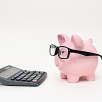 piggy bank and calculator cost of root canal in Huntington Beach