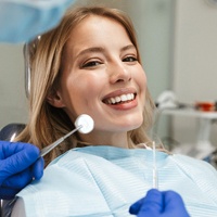 Woman with blonde hair smiling in dental chair