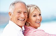 Elderly couple posing by the beach