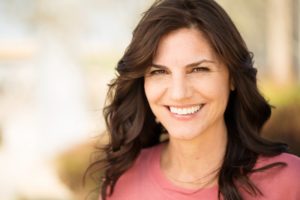 Woman smiling with dental implants in Huntington Beach