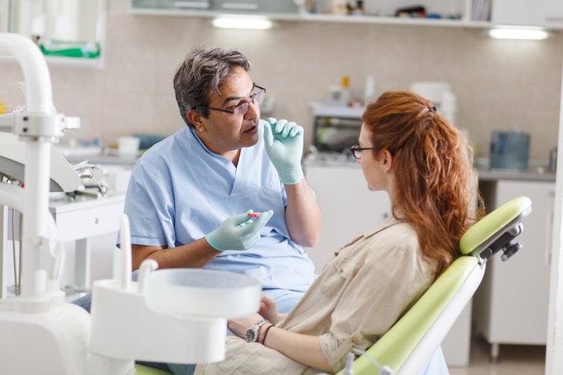 Dentist in Huntington Beach talking to patient  