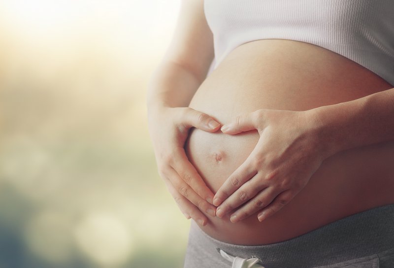 Pregnant woman considering visit to a dentist in Huntington Beach.