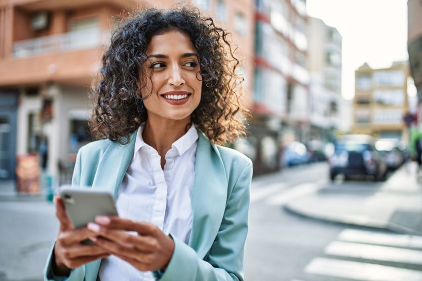 young businesswoman smiling in the street