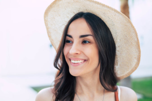 a woman smiling during the summertime