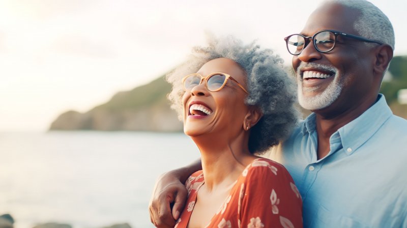 Smiling older couple by lakeside