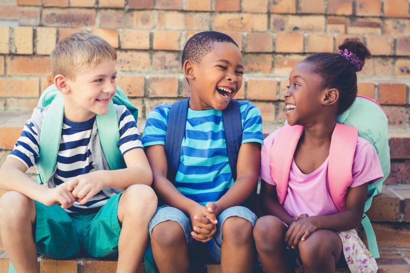 Kids with good oral health smiling after school