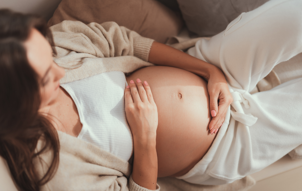 Pregnant woman holding belly