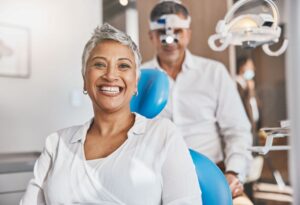 Happy, smiling dental patient in treatment chair